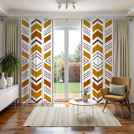 A room with Bogolan Mudcloth Blackout Window Curtains featuring a geometric tribal pattern in black, white, and yellow. The curtains are hanging in a window with a chair and decorative items in the foreground.