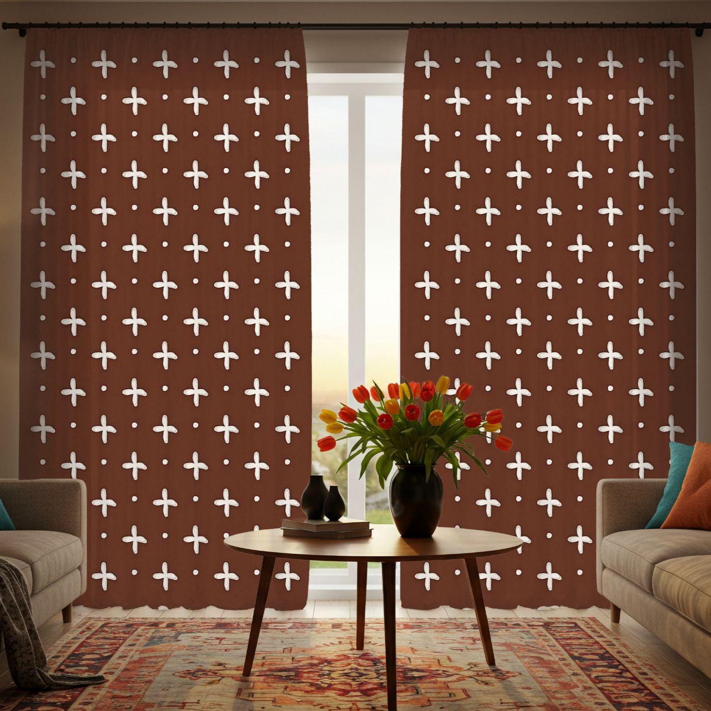 Living room with patterned curtains and a small table with flowers.