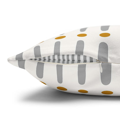 Decorative pillow with gray stripes and gold polka dots on a white background