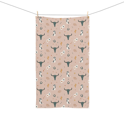 Towel with bull and cow pattern on a pink background
