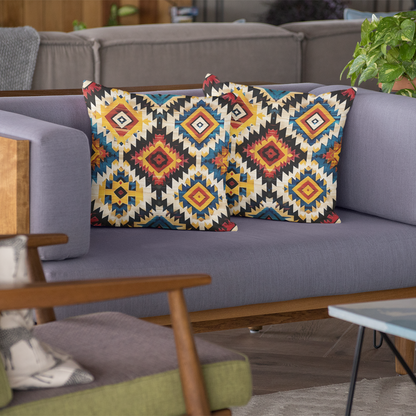 Gray sofa with patterned cushions, green chair, and coffee table in a living room setting.