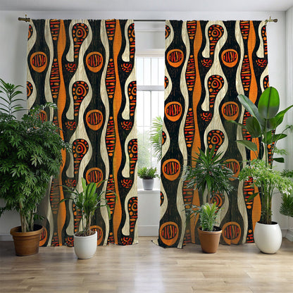 A set of window curtains with a geometric tribal pattern in black, orange, and white, displayed in a room setting with plants and a window.