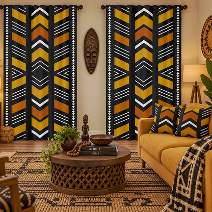 A styled living room featuring two tall window curtains with a bold African-inspired geometric pattern in black, mustard yellow, orange, and white. The room is decorated with a yellow sofa, a carved wooden coffee table, a patterned rug, and a warm, cozy ambiance.