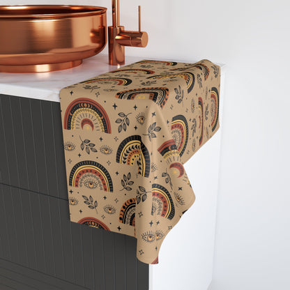 Decorative box with a patterned towel on a kitchen counter with copper fixtures.