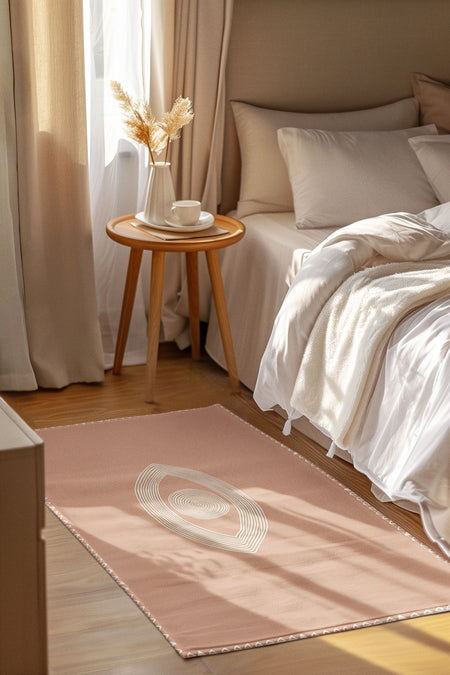 Boho pink floor rug with abstract pattern in cozy bedroom, wood nightstand, neutral bedding