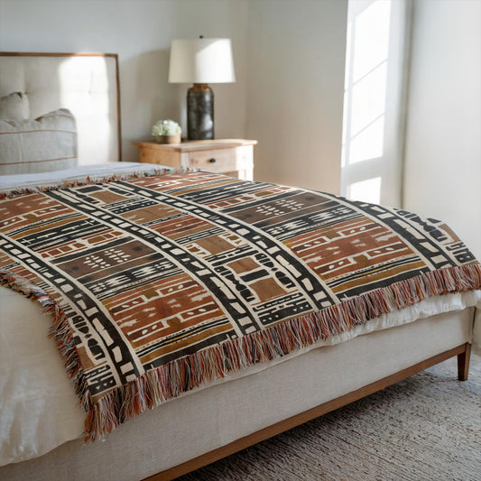 Patterned throw blanket on a bed in a bedroom setting