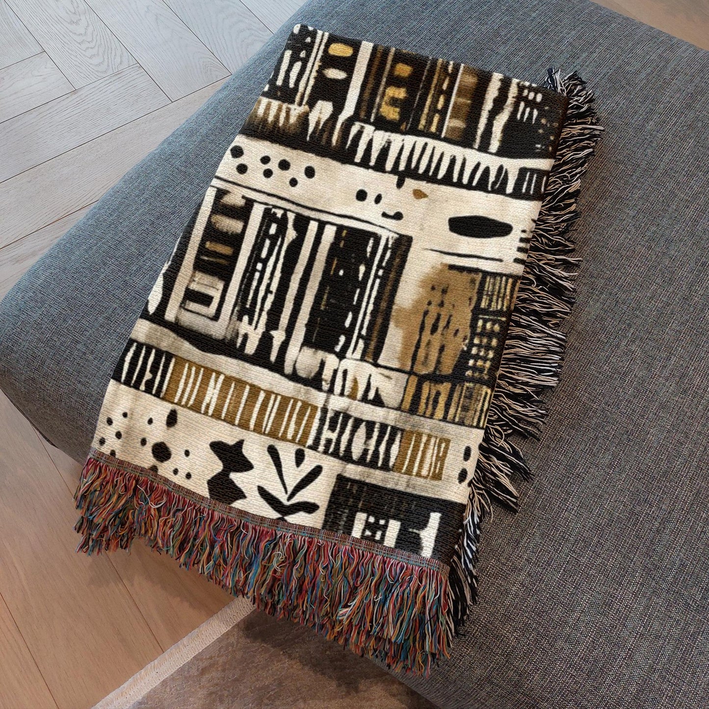 Decorative blanket with tribal pattern on a gray surface