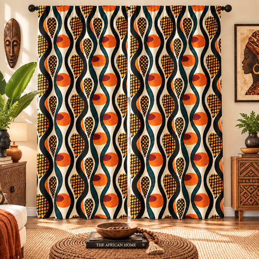 A pair of long window curtains featuring a bold, retro-inspired African wax print pattern with wavy vertical stripes in orange, black, and cream, styled in a warm, decorated living room.