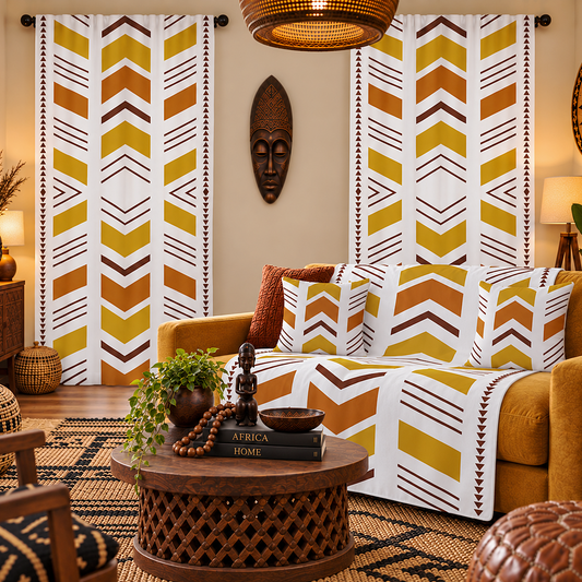 A styled living room featuring a set of white curtains with a bold yellow, brown, and orange chevron pattern. The room is decorated with a mustard yellow sofa, a matching throw blanket, a carved wooden coffee table, and warm ambient lighting.